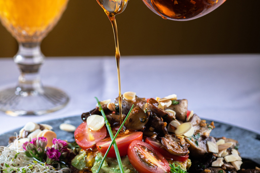 Olive oil drizzling over a fresh salad.