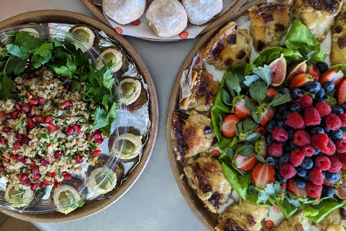 Two catering platters of Mediterranean cuisine